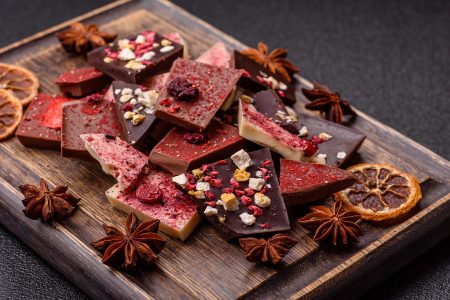 Bar sweet craft artisan chocolate with dried fruits made at home. Craft chocolate as a background for your design